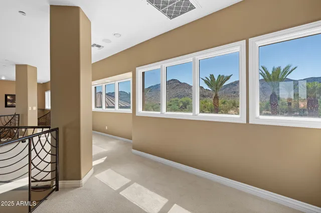 a large white kitchen with white cabinets and stainless steel appliances