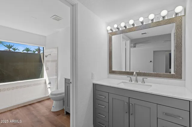 a view of a tennis court with chairs