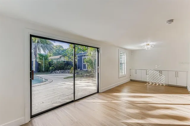 a view of an empty room with glass door