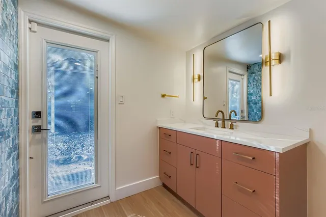 a bathroom with a granite countertop sink a mirror and a