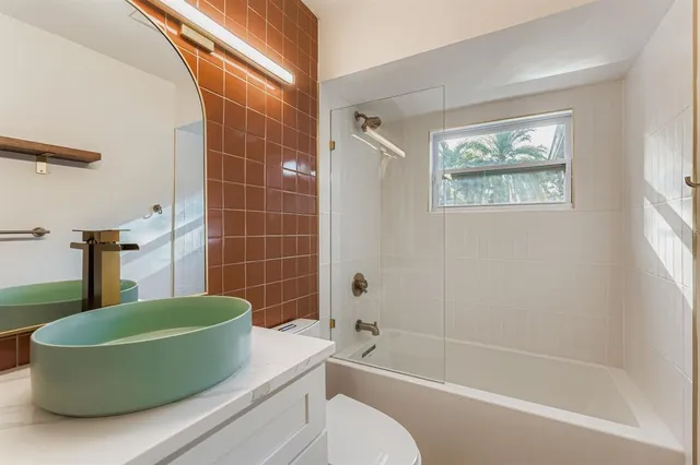 a bathroom with a toilet a sink and bathtub