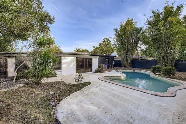 a front view of a house with garden and patio