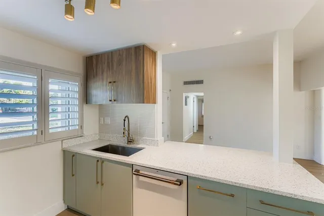 a kitchen with a sink cabinets and window