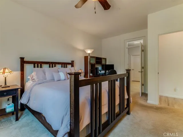 a bedroom with bed and large windows
