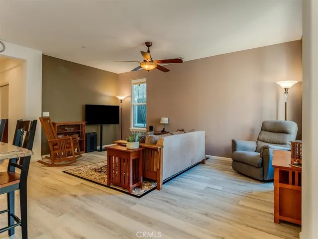 a living room with furniture a flat screen tv and a lamp