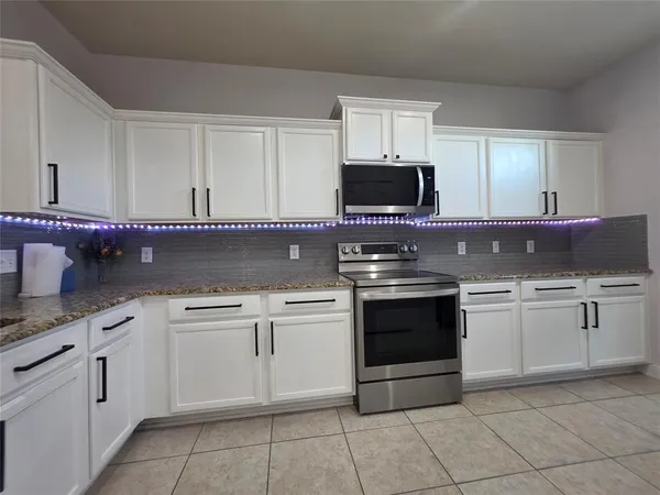 a kitchen with cabinets stainless steel appliances and a sink