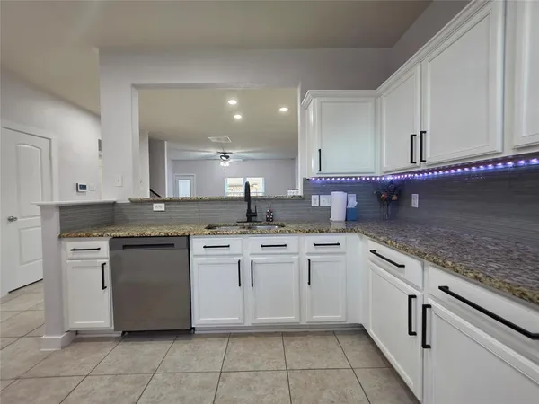 a kitchen with a sink and cabinets