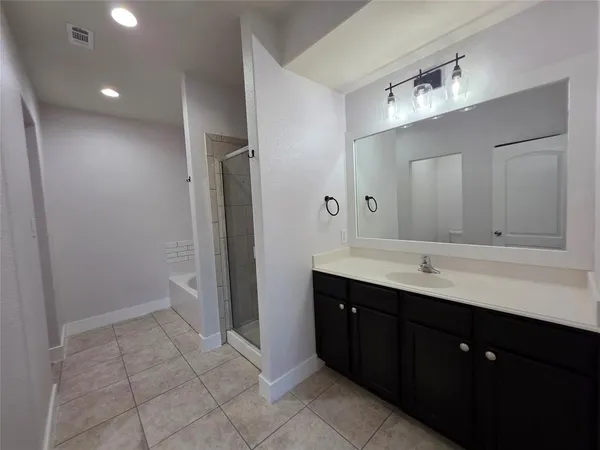 a bathroom with a double vanity sink a mirror and a toilet
