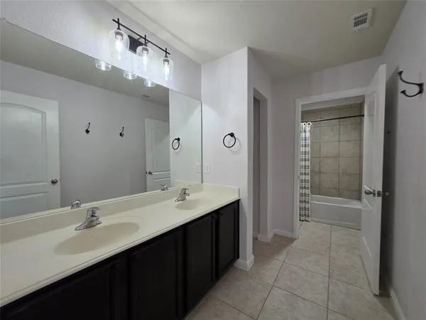 a bathroom with a sink double vanity and a mirror