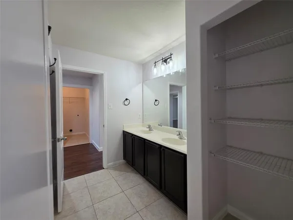 a bathroom with a double vanity sink and mirror