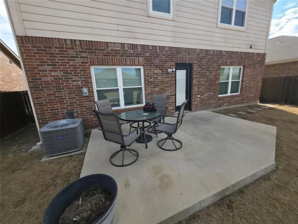 a view of a backyard with table and chairs