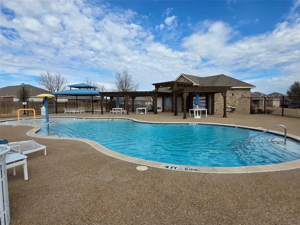 an outdoor view of house with outdoor space and swimming pool