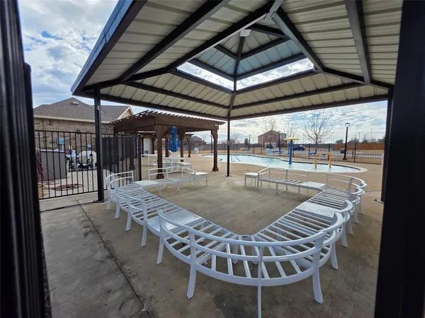 a view of a swimming pool with a patio