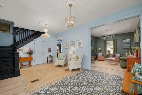 a living room with furniture windows and a chandelier