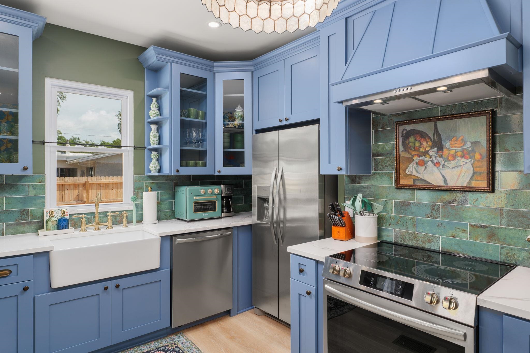 52 Spring Street St. Augustine, FL 32084 - Photo 14 of 45 a kitchen with stainless steel appliances a stove a refrigerator and a sink