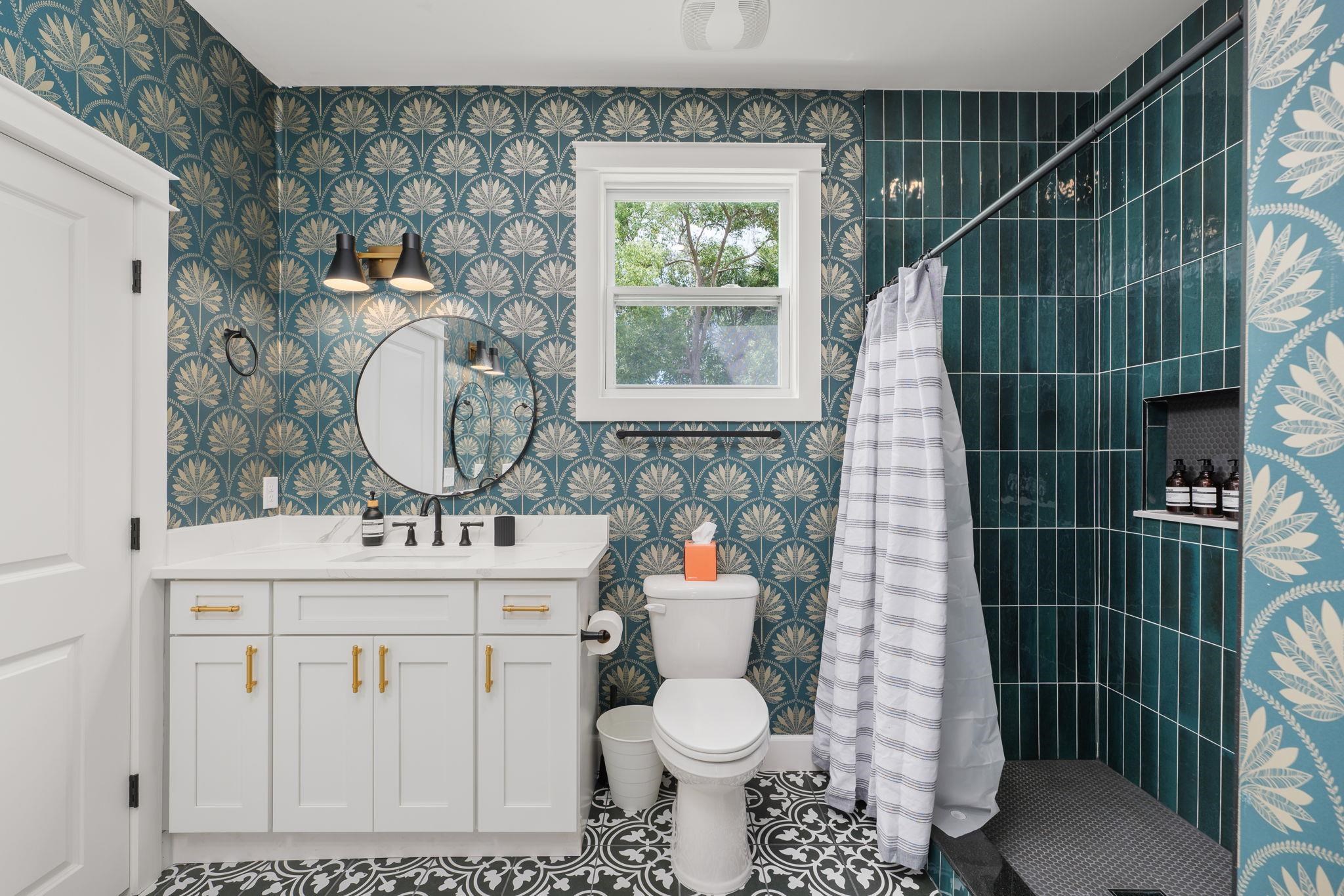 52 Spring Street St. Augustine, FL 32084 - Photo 21 of 45 a bathroom with a toilet a sink and mirror