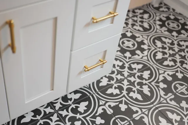 a spacious bedroom with a bed and wooden floor