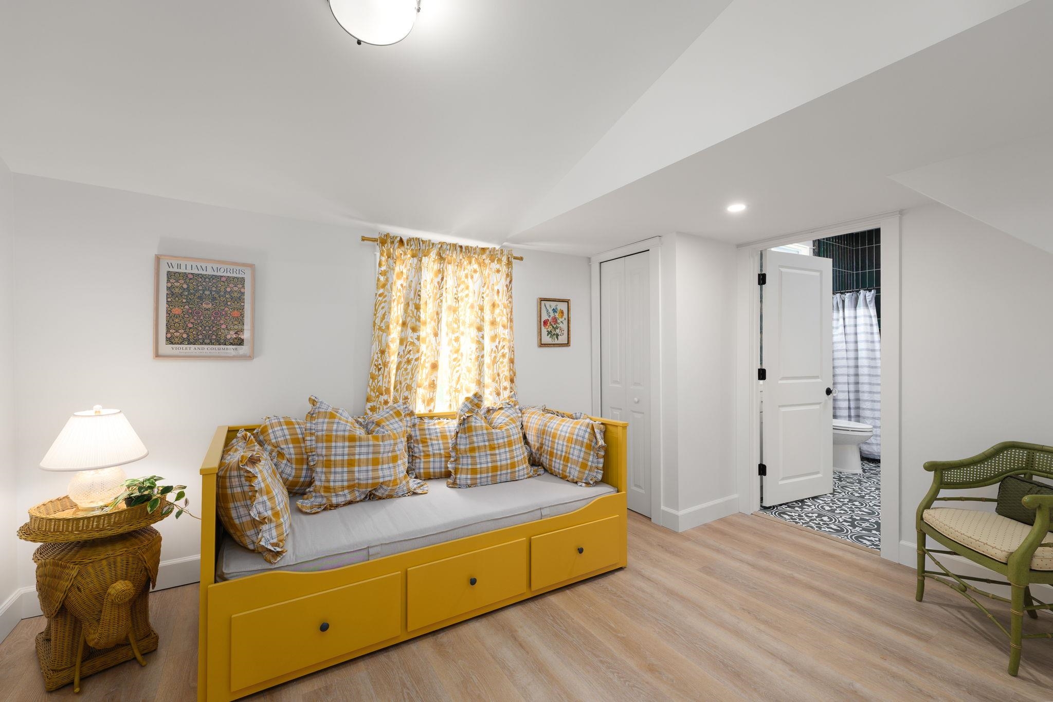 52 Spring Street St. Augustine, FL 32084 - Photo 24 of 45 a spacious bedroom with a bed and wooden floor