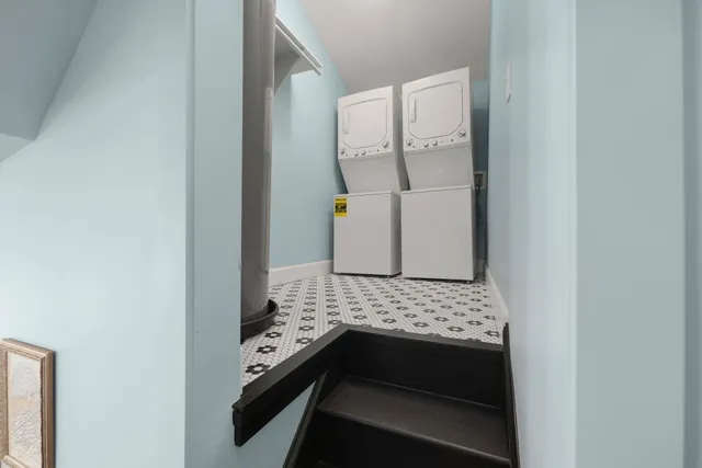 a bedroom with a bed and dresser with wooden floor