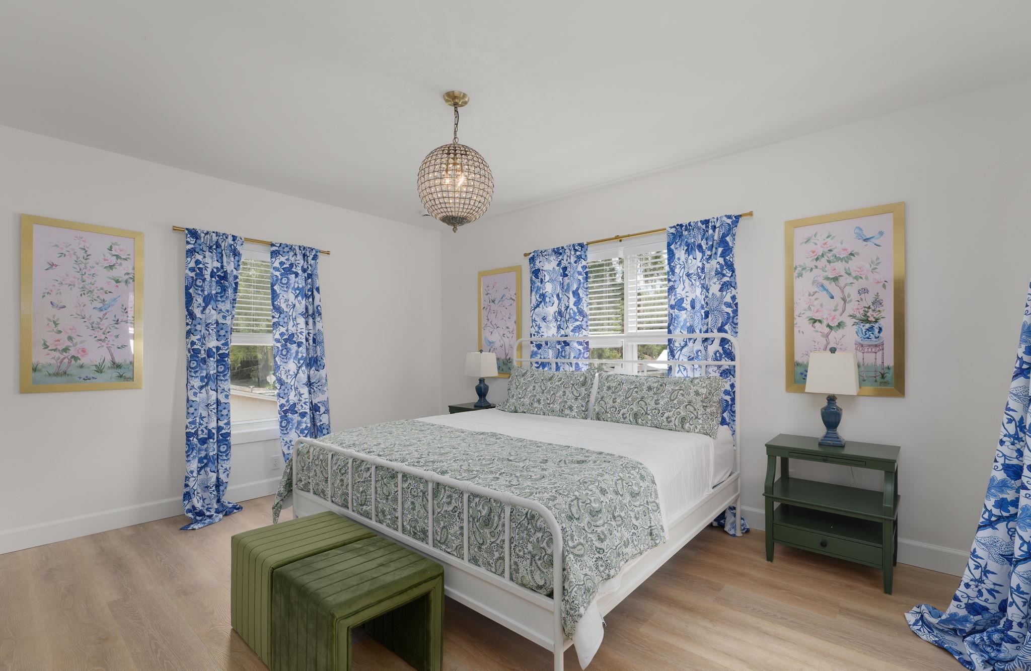 52 Spring Street St. Augustine, FL 32084 - Photo 27 of 45 a bedroom with a bed and dresser with wooden floor