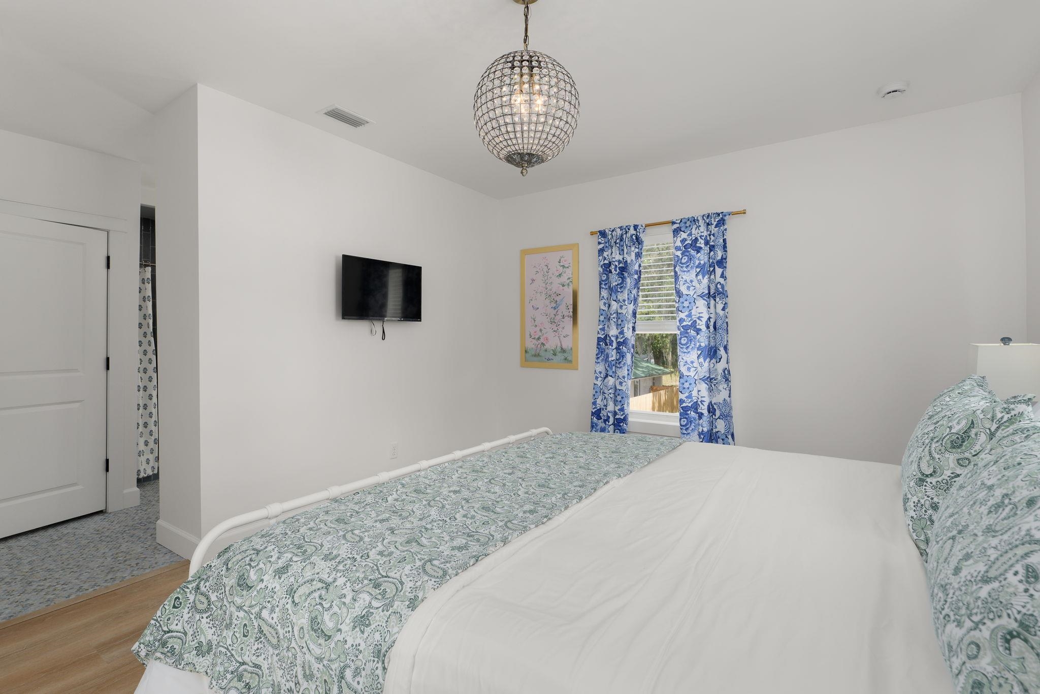 52 Spring Street St. Augustine, FL 32084 - Photo 28 of 45 a bedroom with a bed and a flat tv screen on the dresser