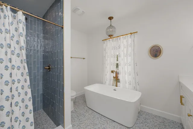 a bathroom with a double vanity sink mirror and bathtub