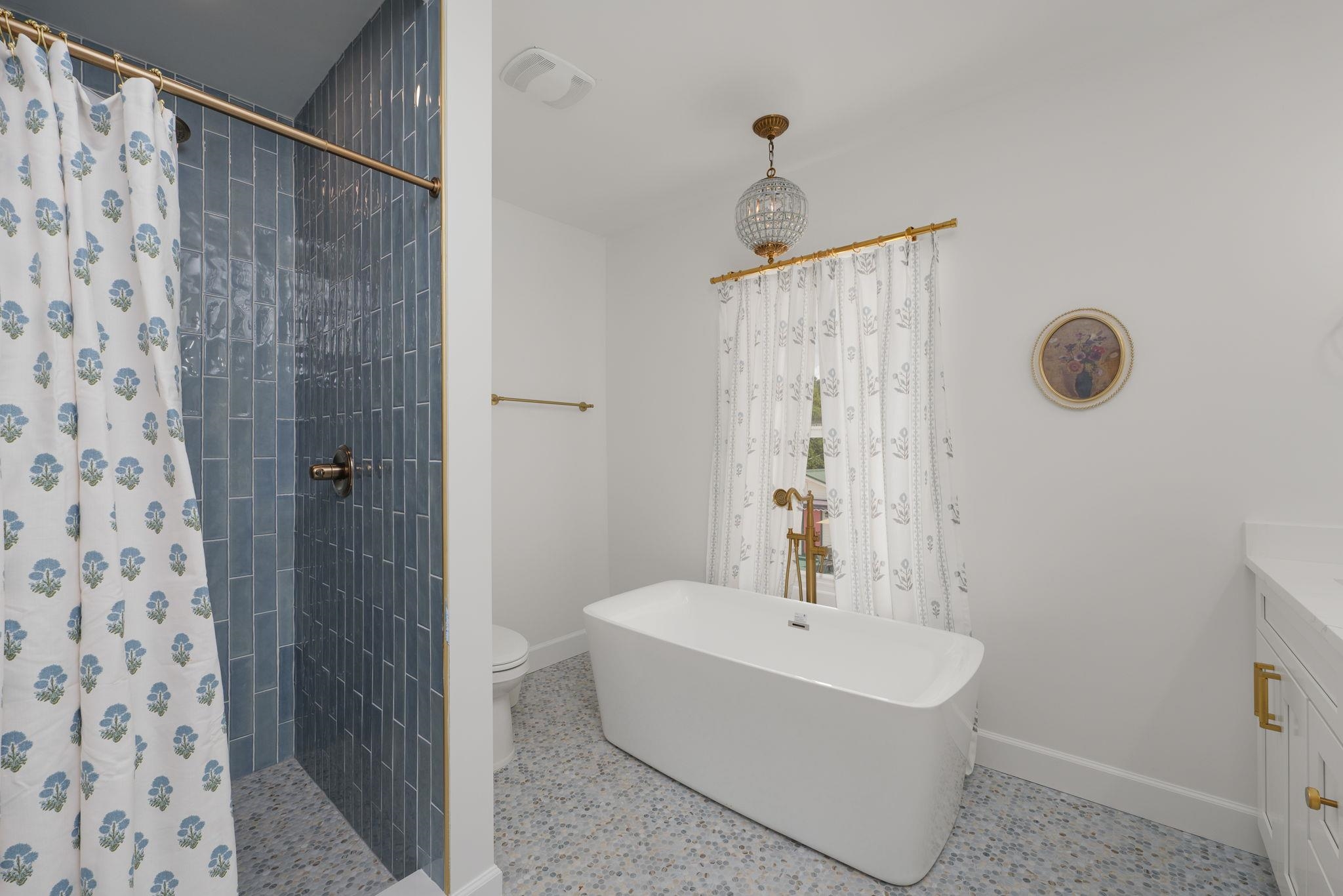 52 Spring Street St. Augustine, FL 32084 - Photo 29 of 45 a bathroom with a sink a mirror and shower