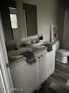 a bedroom with a bed and a night stand