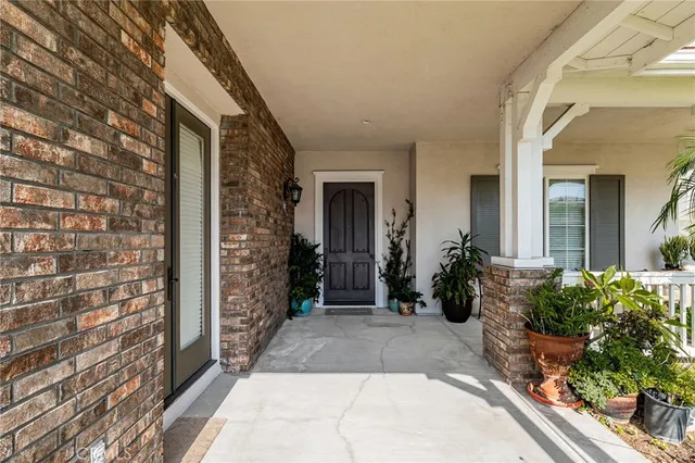 a view of a hallway with wooden floor and entryway