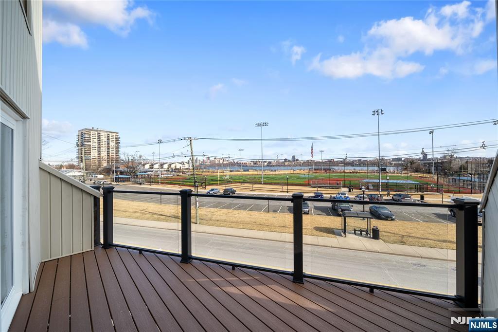 1110 River Road, Unit 102 Edgewater, NJ 07020 - Photo 8 of 18 a terrace with wooden floor barbeque oven and city view