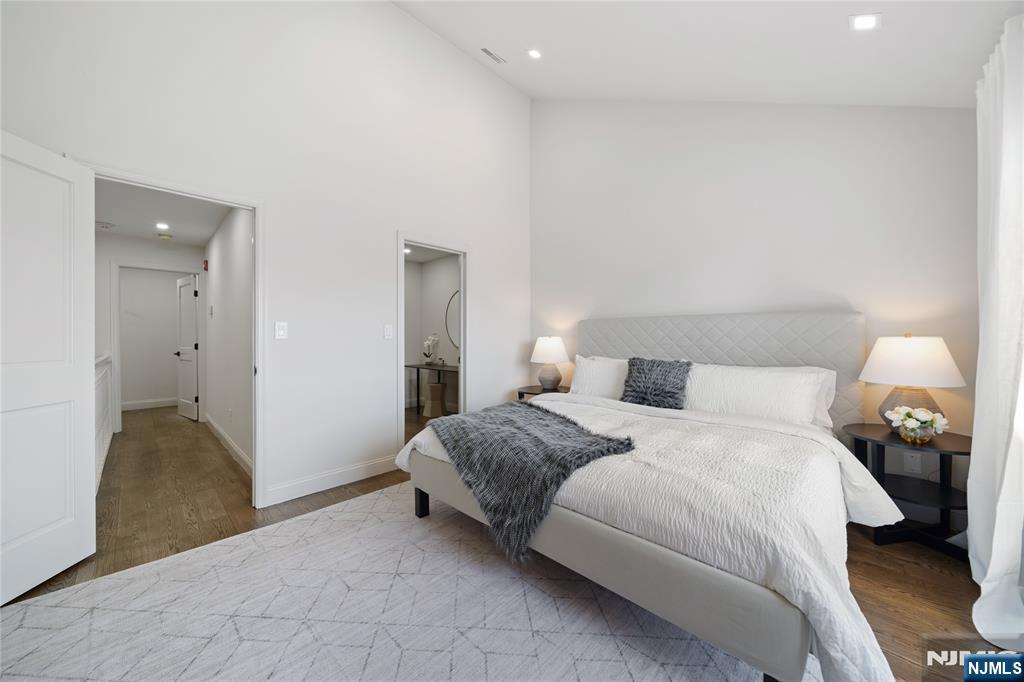 1110 River Road, Unit 102 Edgewater, NJ 07020 - Photo 10 of 18 a bedroom with a bed and a walk in closet