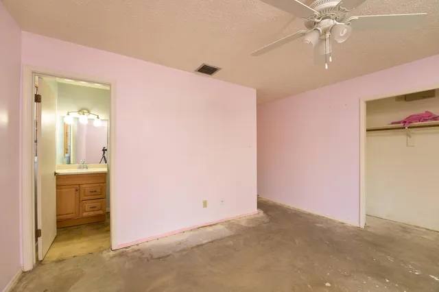 a view of a small house with backyard