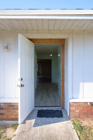 a view of a room with wooden floor