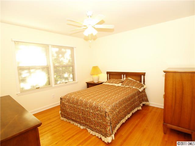 5935 Gate Post Road Charlotte, NC 28211 - Photo 9 of 10 a bedroom with a bed and wooden floor