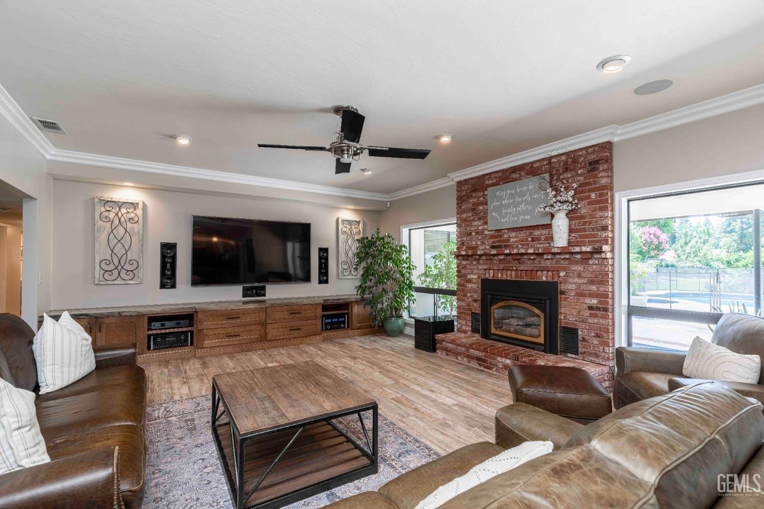 Undisclosed Address Bakersfield, CA 93314 - Photo 13 of 49 a living room with furniture a flat screen tv and a fireplace