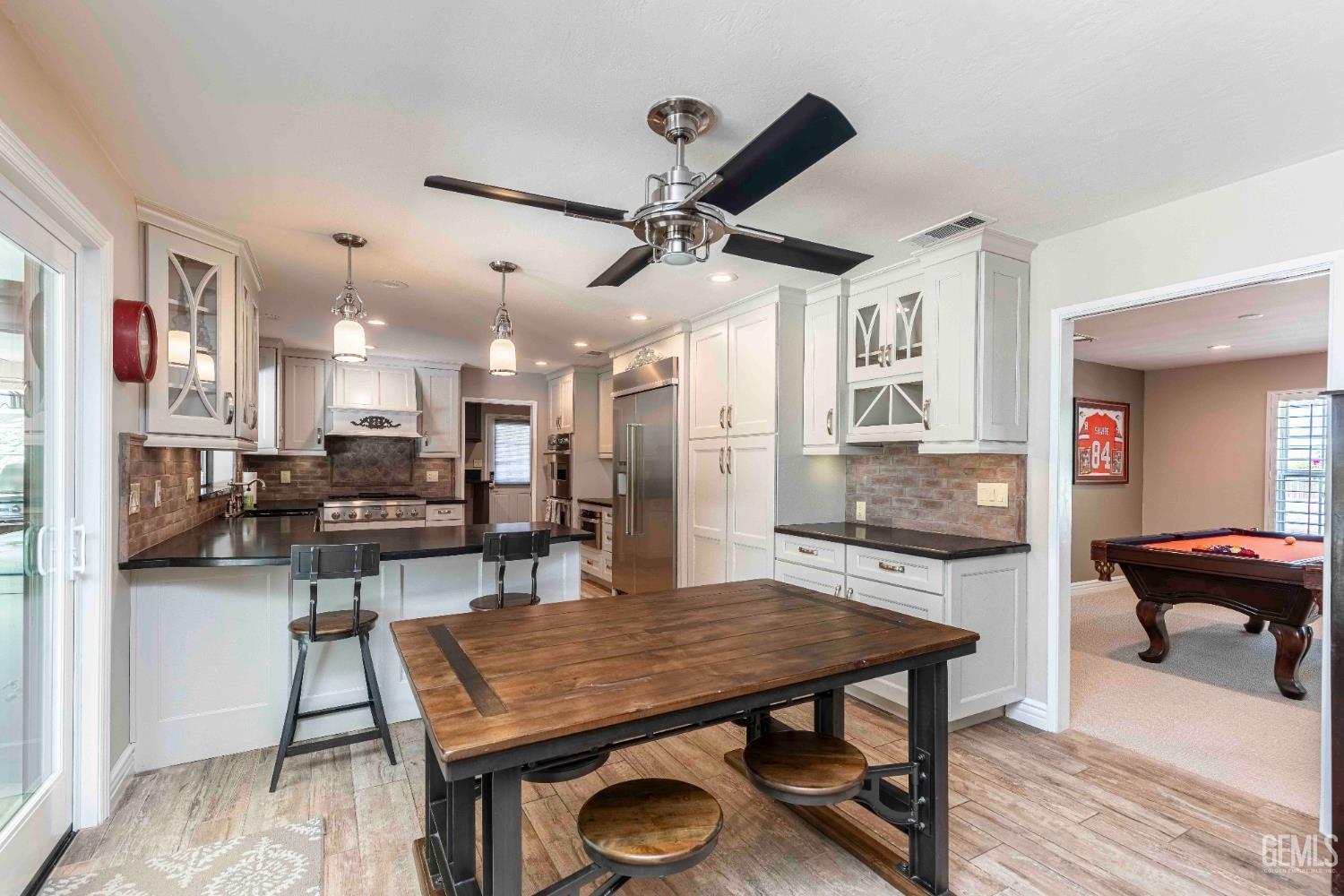 Undisclosed Address Bakersfield, CA 93314 - Photo 14 of 49 a view of a dining room with furniture and wooden floor