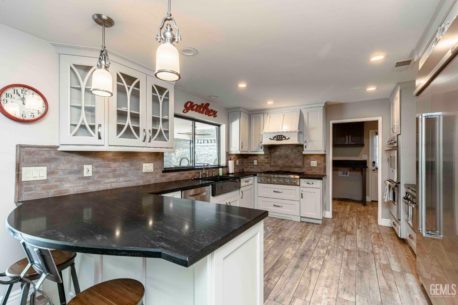 Undisclosed Address Bakersfield, CA 93314 - Photo 15 of 49 a large kitchen with a table and chairs