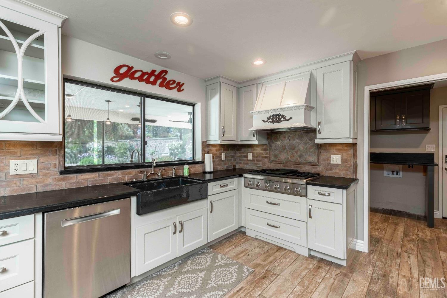 Undisclosed Address Bakersfield, CA 93314 - Photo 16 of 49 a kitchen with stainless steel appliances granite countertop a stove and white cabinets