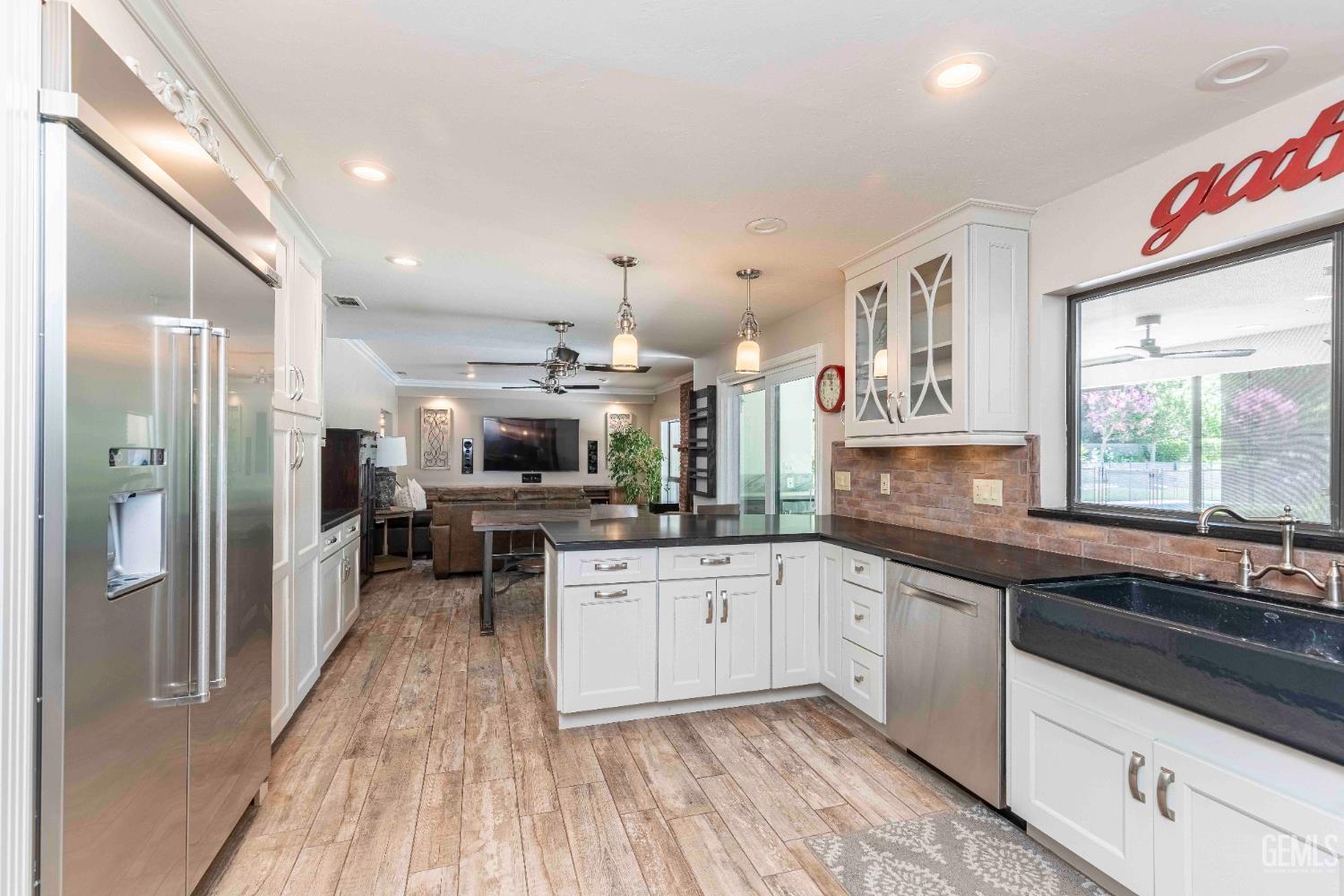 Undisclosed Address Bakersfield, CA 93314 - Photo 18 of 49 a kitchen with stainless steel appliances granite countertop a sink and cabinets
