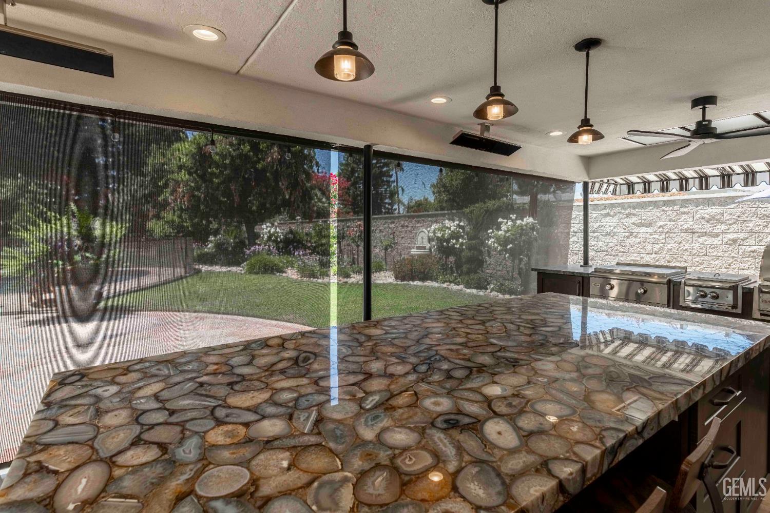 Undisclosed Address Bakersfield, CA 93314 - Photo 19 of 49 a open kitchen with granite countertop a stove a sink and a granite counter top