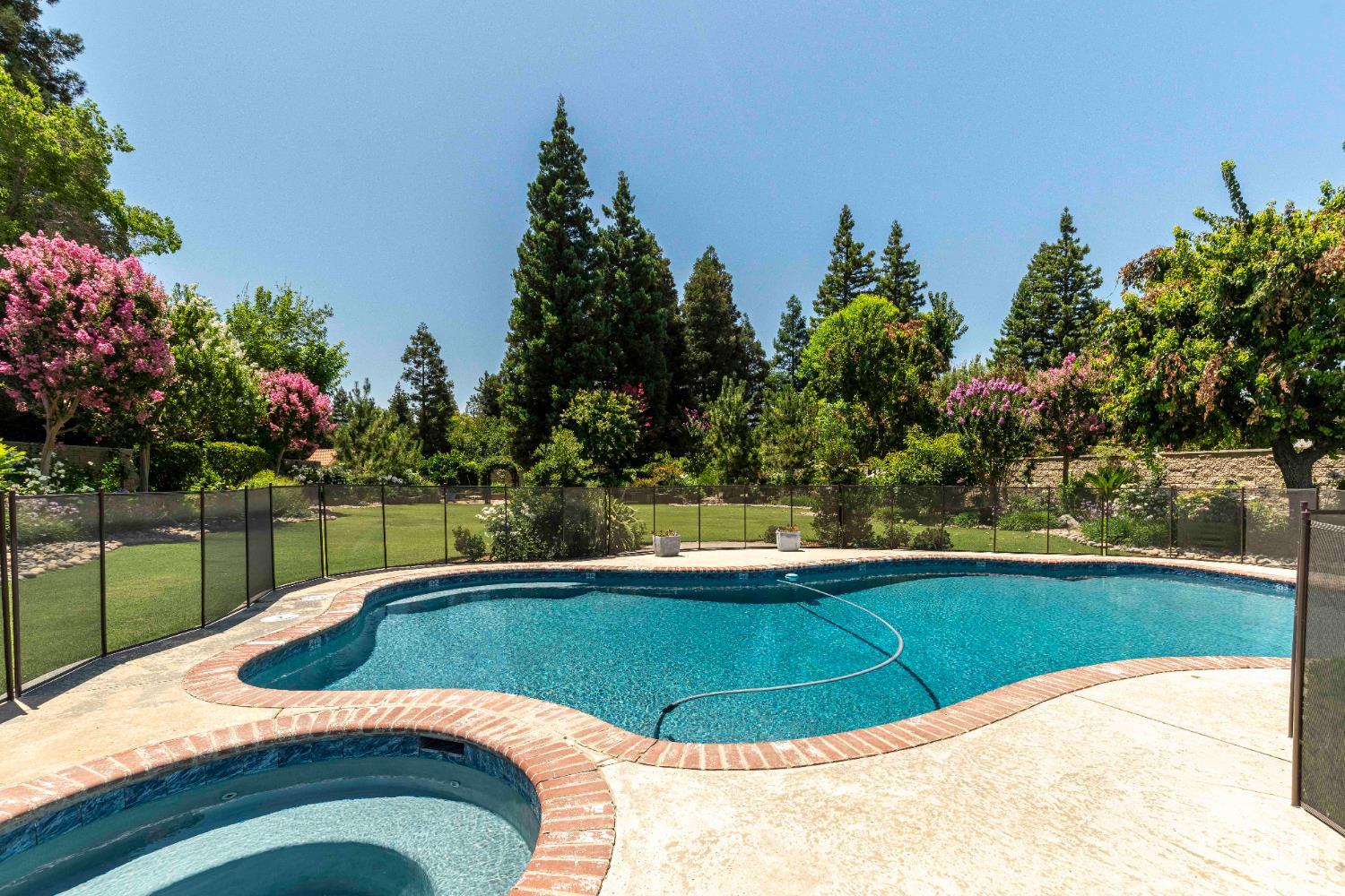Undisclosed Address Bakersfield, CA 93314 - Photo 25 of 49 a view of a swimming pool with a yard and plants