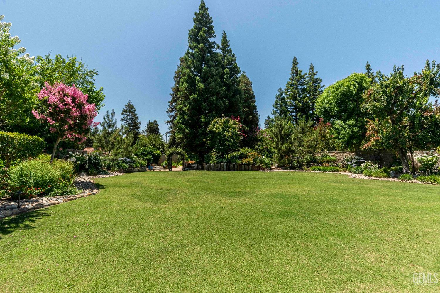 Undisclosed Address Bakersfield, CA 93314 - Photo 27 of 49 a view of a grassy field with trees