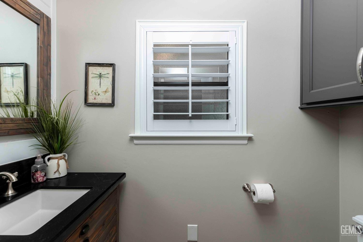 Undisclosed Address Bakersfield, CA 93314 - Photo 31 of 49 a bathroom with a sink a potted plant and a window