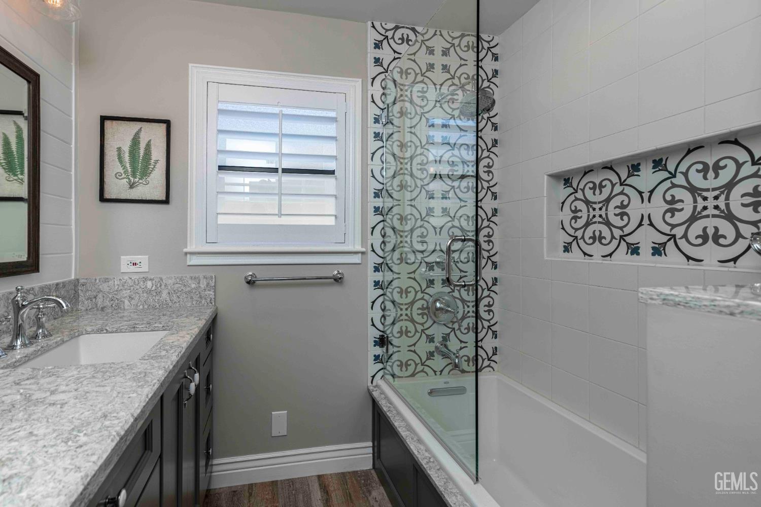 Undisclosed Address Bakersfield, CA 93314 - Photo 42 of 49 a bathroom with a granite countertop sink a mirror a vanity and a shower