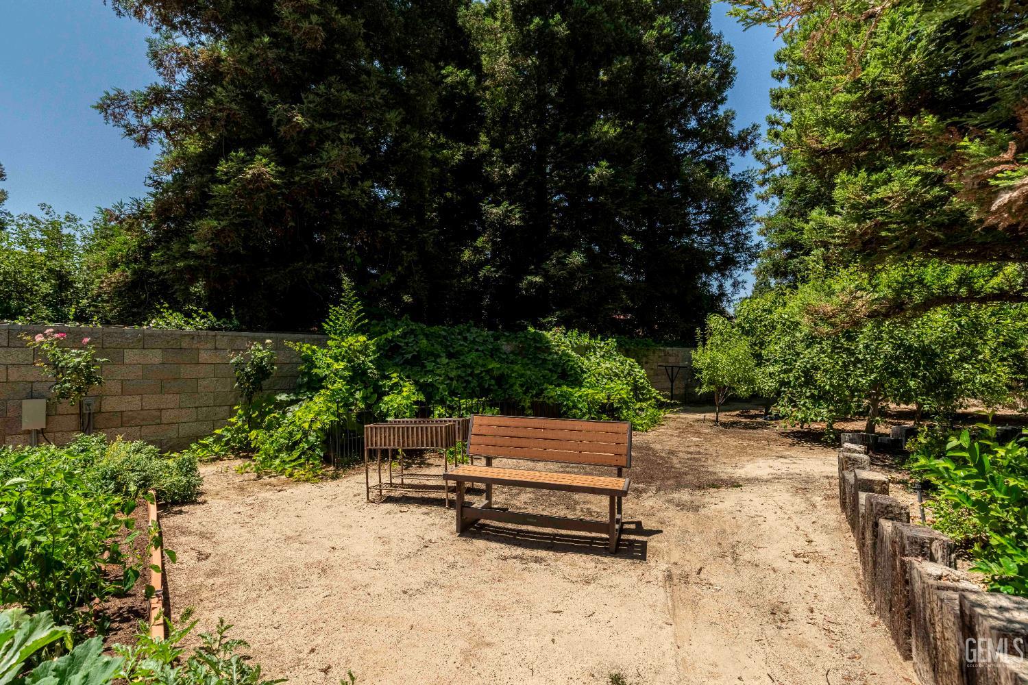 Undisclosed Address Bakersfield, CA 93314 - Photo 46 of 49 a wooden bench sitting in backyard of a house