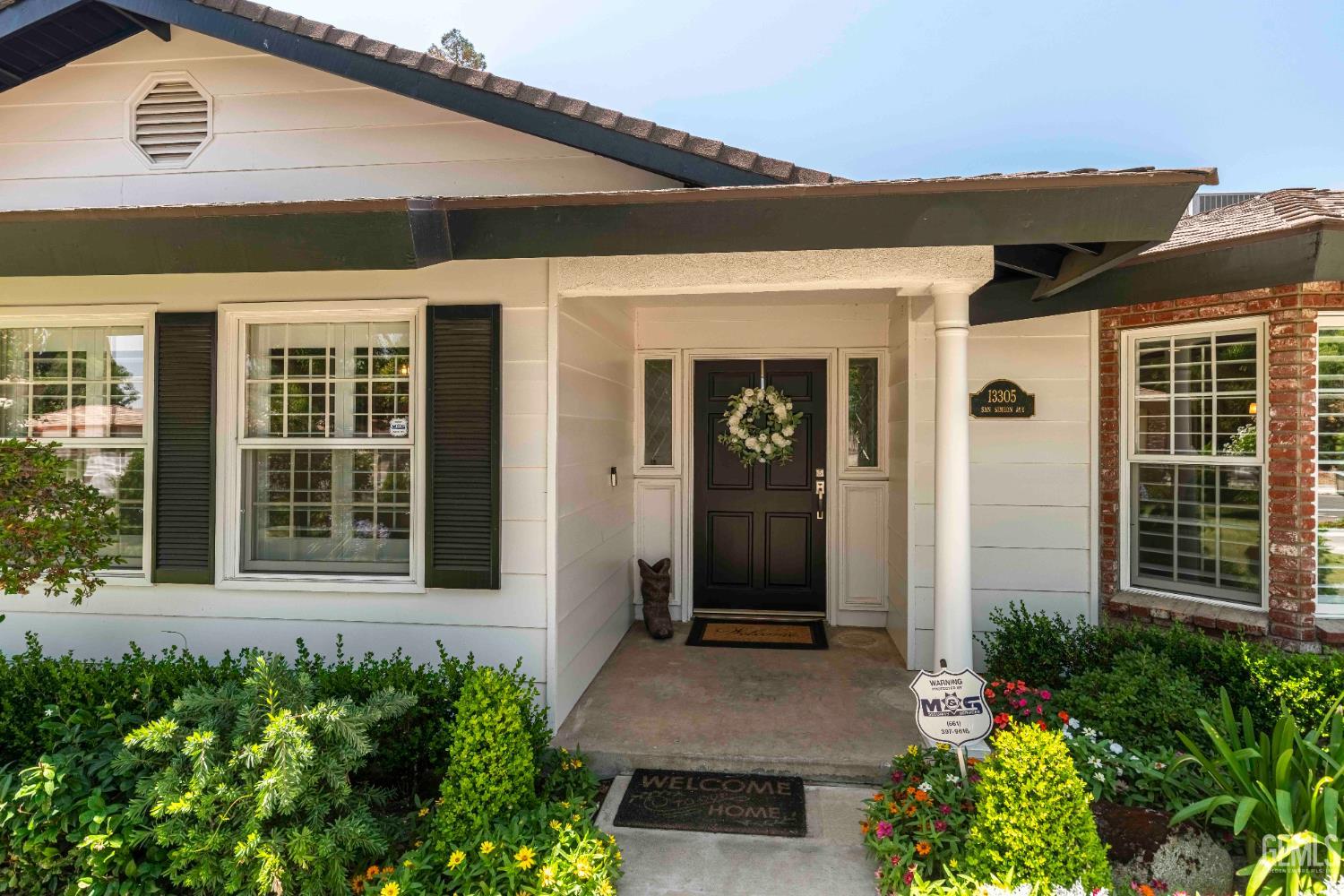 Undisclosed Address Bakersfield, CA 93314 - Photo 5 of 49 a front view of a house with a garden