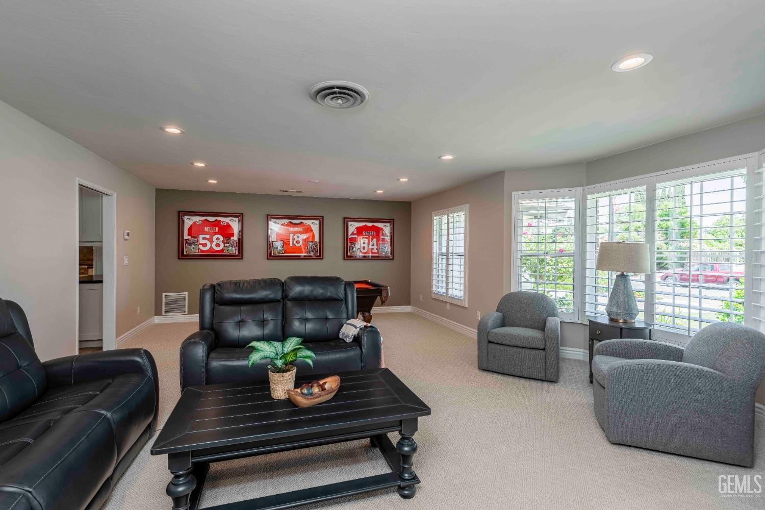 Undisclosed Address Bakersfield, CA 93314 - Photo 7 of 49 a living room with furniture a floor to ceiling window and a flat screen tv