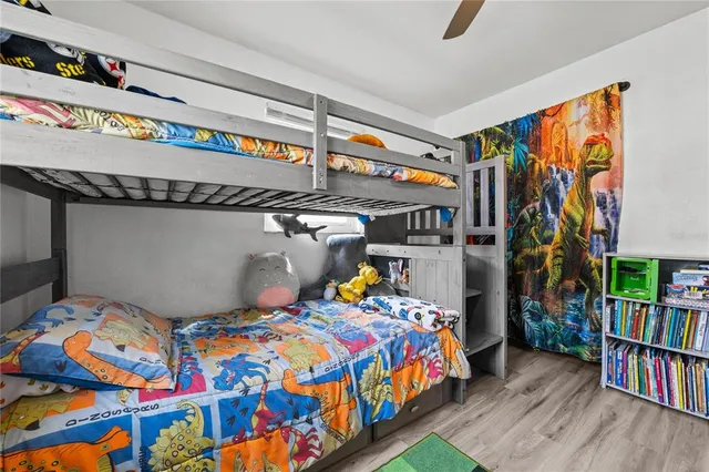 a bedroom with bed and a book shelf