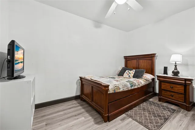 a bedroom with a bed and a flat screen tv