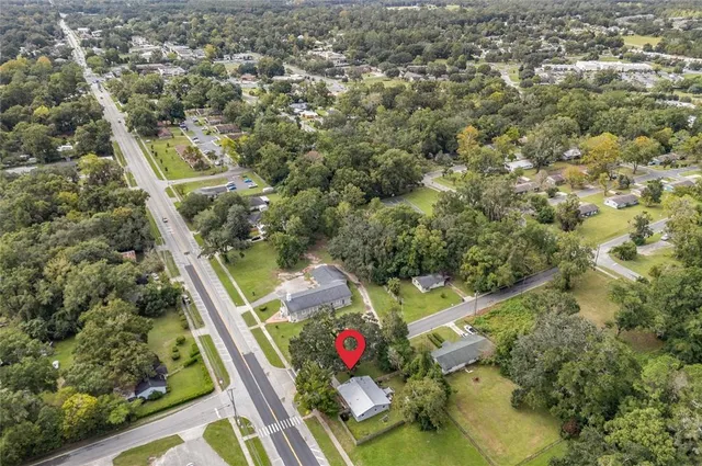 an aerial view of residential house with outdoor space and tree